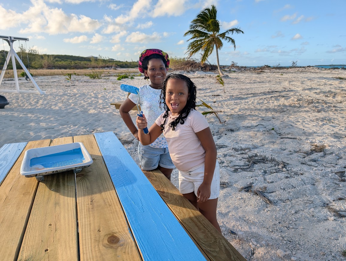 Children of Rolleville painting a picnic table at Maud Anderson Park